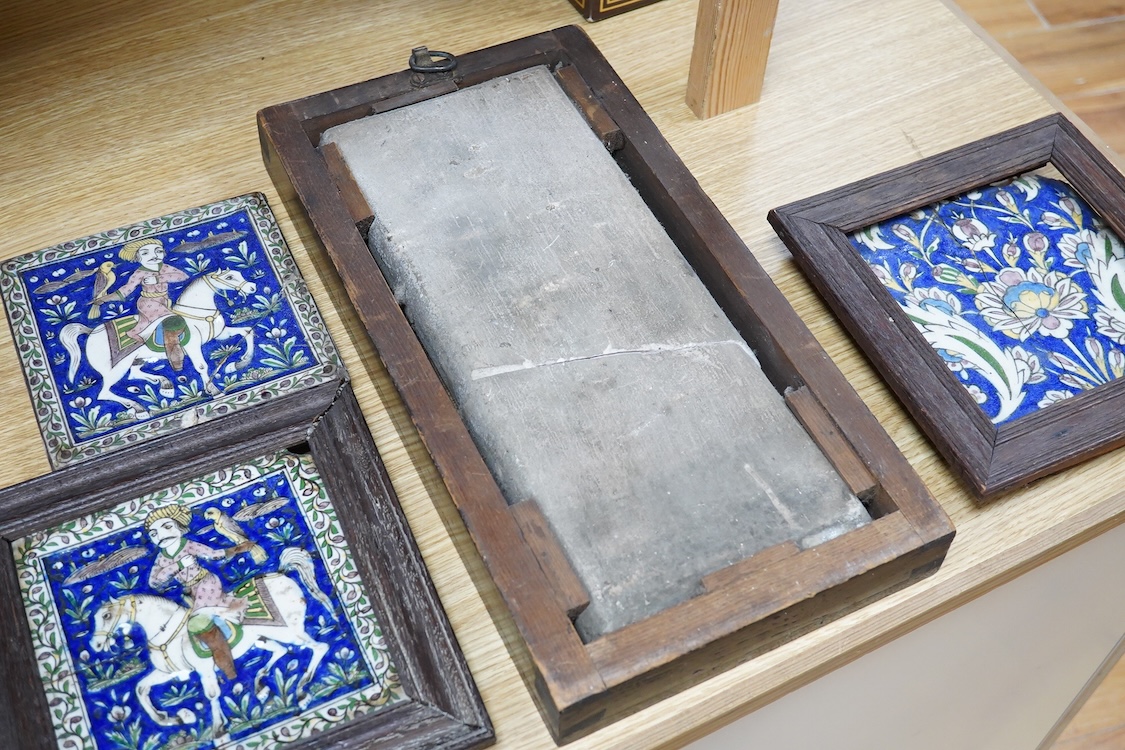 Four 18th/19th century Persian tiles, two depicting horses and riders and abstract flowers, three framed, largest 40 x 21cm